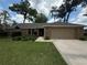 Charming brick home with a two-car garage, well-manicured lawn, and mature trees at 2921 Se 38 Pl, Ocala, FL 34480