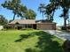 Charming single-story home with a well-manicured lawn, mature trees, and a two-car garage at 2921 Se 38 Pl, Ocala, FL 34480