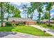 Charming single-story brick home with well-manicured lawn and mature trees offering shade at 2921 Se 38 Pl, Ocala, FL 34480