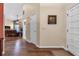 Hallway with wood flooring leading to living room and entrance door at 2921 Se 38 Pl, Ocala, FL 34480