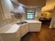 Cozy kitchen with white cabinets, white appliances, and laminate countertops at 2921 Se 38 Pl, Ocala, FL 34480