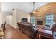 Living room with a brick fireplace, wood floors, a ceiling fan, and leather furniture at 2921 Se 38 Pl, Ocala, FL 34480