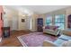 Cozy living room featuring wood floors, a comfortable seating arrangement, and natural light at 2921 Se 38 Pl, Ocala, FL 34480