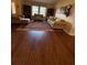 Inviting living room featuring hardwood floors, bookshelves, and comfortable seating with ample natural light at 2921 Se 38 Pl, Ocala, FL 34480