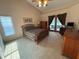 Spacious main bedroom with a vaulted ceiling, carpeted floors, and access to the outdoors at 2921 Se 38 Pl, Ocala, FL 34480