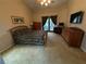 Spacious bedroom featuring neutral tones, a ceiling fan, and a private door leading to an outdoor area at 2921 Se 38 Pl, Ocala, FL 34480