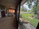 View of a sunny, tiled-floor sunroom, with a glimpse of the well-maintained backyard and green lawn at 2921 Se 38 Pl, Ocala, FL 34480