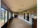 Bright sunroom with tiled floors, plenty of natural light, and doors leading to the home's interior at 2921 Se 38 Pl, Ocala, FL 34480