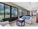 Enclosed sunroom boasts tile flooring, neutral color scheme, and large windows with view of yard at 2921 Se 38 Pl, Ocala, FL 34480