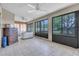 Bright sunroom with tile floor, ceiling fans, large windows overlooking the backyard, and neutral interior at 2921 Se 38 Pl, Ocala, FL 34480
