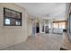 Bright enclosed sunroom featuring tile flooring, neutral color scheme, and glass doors at 2921 Se 38 Pl, Ocala, FL 34480