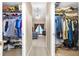 Walk-in closet leading to a bedroom offers ample storage space with clothing racks and shoe shelves at 2921 Se 38 Pl, Ocala, FL 34480