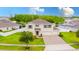 Lovely two-story home with a three car garage, well-manicured lawn, and neatly landscaped yard at 383 Blue Lake Cir, Kissimmee, FL 34758