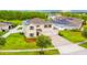 Two story home with a three car garage, a well manicured lawn and beautiful landscaping at 383 Blue Lake Cir, Kissimmee, FL 34758