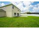 Backyard featuring green grass, patio, and privacy fence at 383 Blue Lake Cir, Kissimmee, FL 34758