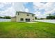 Large backyard featuring green grass, patio, and privacy fence at 383 Blue Lake Cir, Kissimmee, FL 34758
