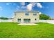 Two-story house with a backyard, lush green lawn, and a fenced perimeter at 383 Blue Lake Cir, Kissimmee, FL 34758
