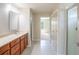 Bathroom featuring a single vanity, quartz countertops, and a doorway to a walk-in shower at 383 Blue Lake Cir, Kissimmee, FL 34758