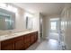 Bathroom with dual sinks, wood cabinets, and shower at 383 Blue Lake Cir, Kissimmee, FL 34758