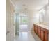 Bathroom with double vanity, neutral countertops, and easy access to the bedroom and shower at 383 Blue Lake Cir, Kissimmee, FL 34758
