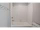 Bright bathroom featuring a tiled shower-tub combo with modern fixtures and a white toilet at 383 Blue Lake Cir, Kissimmee, FL 34758