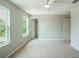 Bright bedroom featuring neutral carpet, a ceiling fan, and natural light from two windows at 383 Blue Lake Cir, Kissimmee, FL 34758