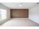 Bright bedroom features an accent wall, carpeted floors, and natural light at 383 Blue Lake Cir, Kissimmee, FL 34758
