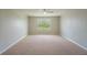 Large bedroom featuring neutral walls, carpet, and a bright window showcasing the backyard at 383 Blue Lake Cir, Kissimmee, FL 34758