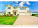 Charming two-story home featuring a brick driveway, a well-maintained lawn and beautiful landscaping at 383 Blue Lake Cir, Kissimmee, FL 34758