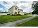 Landscaped front yard shows off this home with a spacious driveway at 383 Blue Lake Cir, Kissimmee, FL 34758