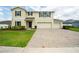 Charming two-story home boasts a paver driveway and a three-car garage at 383 Blue Lake Cir, Kissimmee, FL 34758