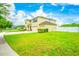 Spacious two-story home with a three car garage, well-manicured lawn, and partial white fence at 383 Blue Lake Cir, Kissimmee, FL 34758