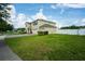 Exterior of home showcasing lawn, landscaping, and a two-car garage at 383 Blue Lake Cir, Kissimmee, FL 34758