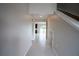 Hallway leads to the open kitchen and living space with lots of light at 383 Blue Lake Cir, Kissimmee, FL 34758