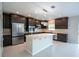 This spacious kitchen features stainless appliances, and dark cabinetry at 383 Blue Lake Cir, Kissimmee, FL 34758