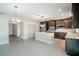 Modern kitchen with stainless steel appliances and dark wood cabinetry, an adjacent island with light countertops at 383 Blue Lake Cir, Kissimmee, FL 34758