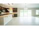 Open kitchen features sleek dark cabinets, stainless appliances, and access to the backyard at 383 Blue Lake Cir, Kissimmee, FL 34758