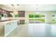 Open-concept kitchen featuring stainless steel appliances, a large island, and sliding glass doors to the patio at 383 Blue Lake Cir, Kissimmee, FL 34758