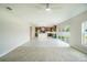 Open-concept living room with tile flooring flowing into a modern kitchen with a large island at 383 Blue Lake Cir, Kissimmee, FL 34758