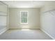 Spacious walk-in closet with carpeted floors, a window, and shelving racks for ample storage at 383 Blue Lake Cir, Kissimmee, FL 34758