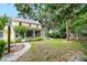 Expansive backyard featuring lush greenery, mature trees, and a charming screened-in porch at 1226 Se 9Th Ave, Ocala, FL 34471