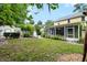 Well-maintained backyard with lush lawn, privacy landscaping, and a lovely screened-in porch at 1226 Se 9Th Ave, Ocala, FL 34471