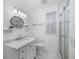 Updated bathroom featuring a glass shower, modern fixtures, and classic white tile at 1226 Se 9Th Ave, Ocala, FL 34471
