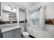 Charming bathroom features classic fixtures, a marble vanity, and ample natural light from the window at 1226 Se 9Th Ave, Ocala, FL 34471