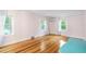 Bedroom features wood floors, neutral walls, lots of light from two windows with sheer curtains at 1226 Se 9Th Ave, Ocala, FL 34471