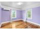 Bedroom featuring hardwood flooring, two bright windows and cooling unit at 1226 Se 9Th Ave, Ocala, FL 34471