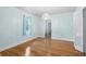 Bright bedroom featuring wood floors, a chandelier, and a window with blue curtains at 1226 Se 9Th Ave, Ocala, FL 34471