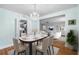 Elegant dining room with stylish chandelier, set table, and views of the living room and kitchen at 1226 Se 9Th Ave, Ocala, FL 34471
