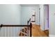 Hallway with hardwood flooring, staircase, and access to bathroom and bedrooms at 1226 Se 9Th Ave, Ocala, FL 34471