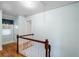 Bright hallway features hardwood floors, stairs with white railing, and natural light from the window at 1226 Se 9Th Ave, Ocala, FL 34471
